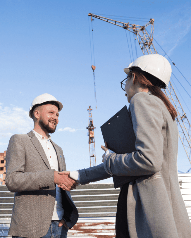 smiling engineers shaking hands construction site architectural project 1
