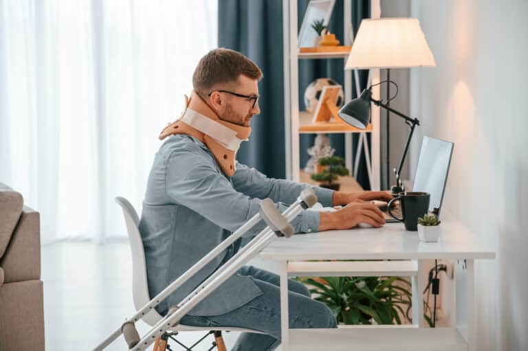 working from home by using laptop man with crutch 2023 01 18 07 08 44 utc scaled